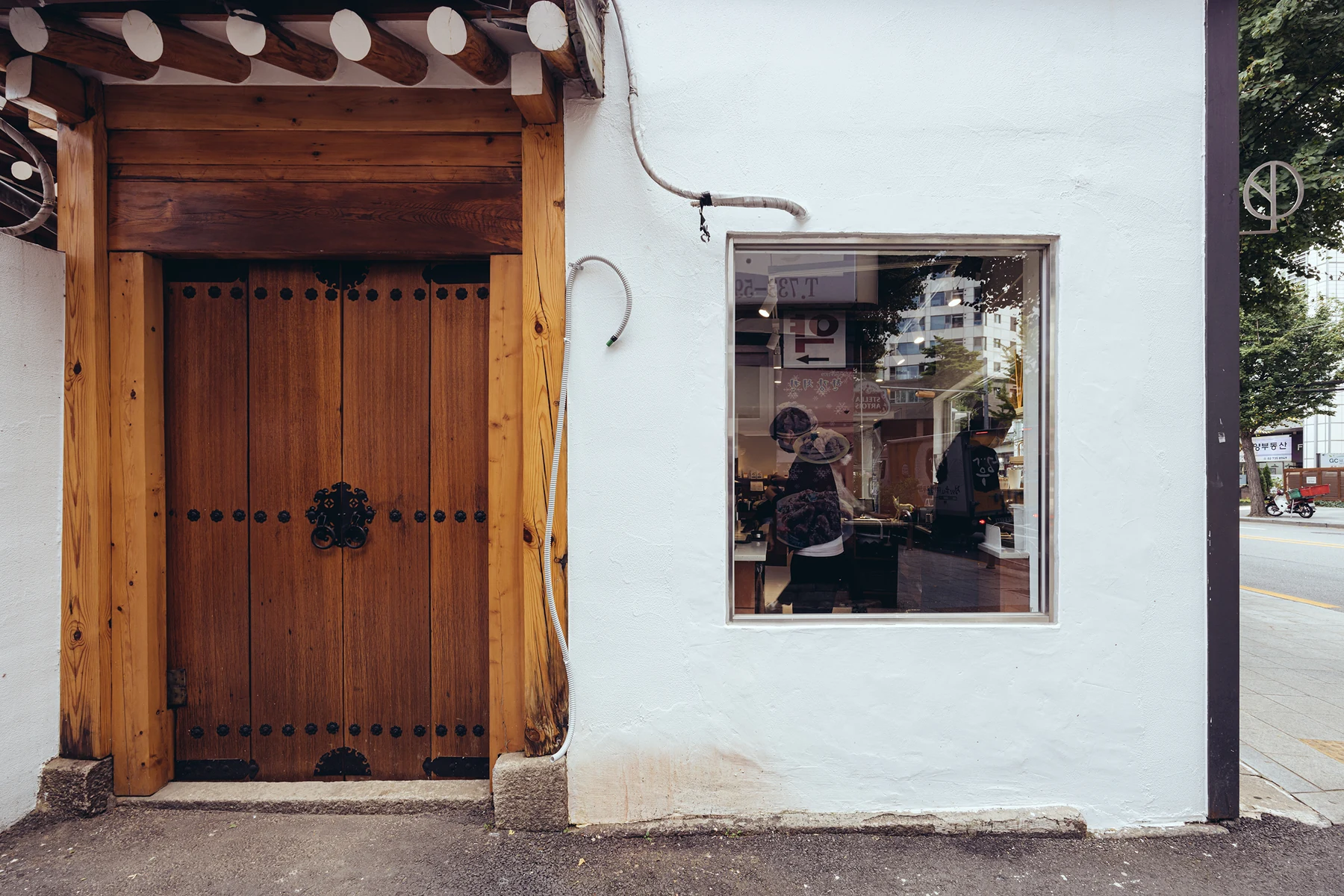 Official exterior of Namusairo Naeja with a wooden hanok door and square window